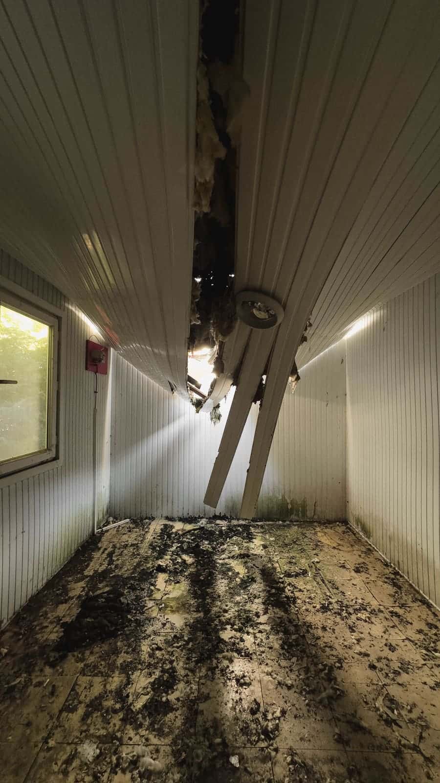 Ceiling damaged by water from a bathroom above